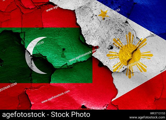 flags of Maldives and Philippines painted on cracked wall