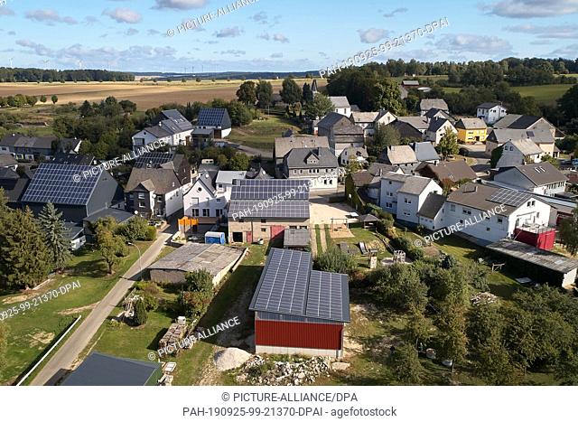 19 September 2019, Rhineland-Palatinate: In the Hunsrück village of Schorbach, numerous photovoltaic systems are installed on the house roofs