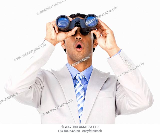 Surprised businessman looking through binoculars isolated on a white background