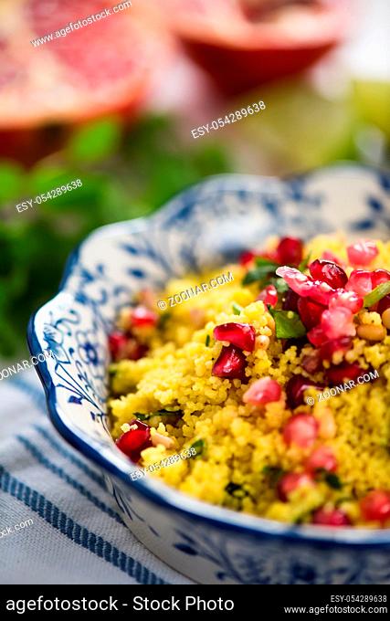 Close view, couscous salad with pomegranate seeds