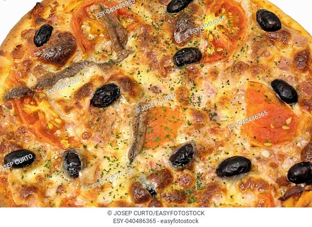 detail of a pizza with anchovy tomato olives