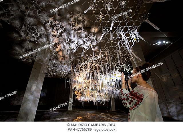 A visitor takes pictures of the installation 'Epiphyte Membrane' of the artist Philip Beesley during the exhibition project 'Photography Playground' in the...