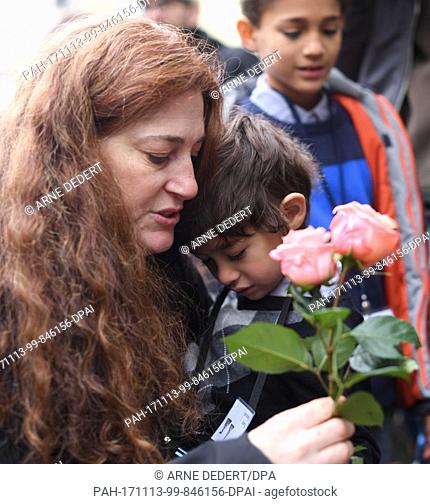 Mandy Eisemann from Dickerson/Maryland, US, relative of the Cohn Jewish family, holding her son, Levi (4), in her arms during the laying down of the...