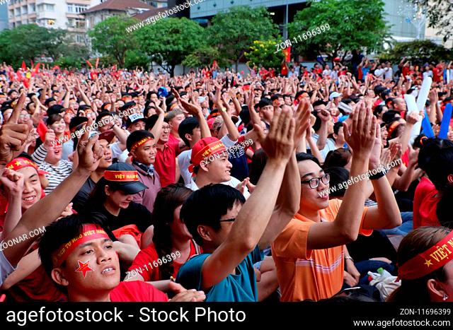 HO CHI MINH CITY, VIET NAM- JAN 27, 2018: Exiting atmosphere of Vietnamese football fans when watch the AFC U23 final match from outdoor Tv screen at Nguyen Hue...