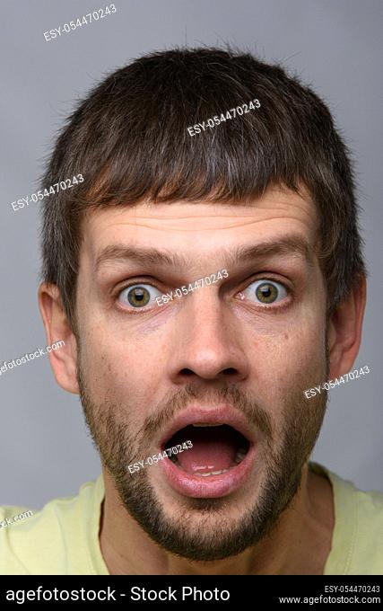 Close-up portrait of a very surprised man of European appearance