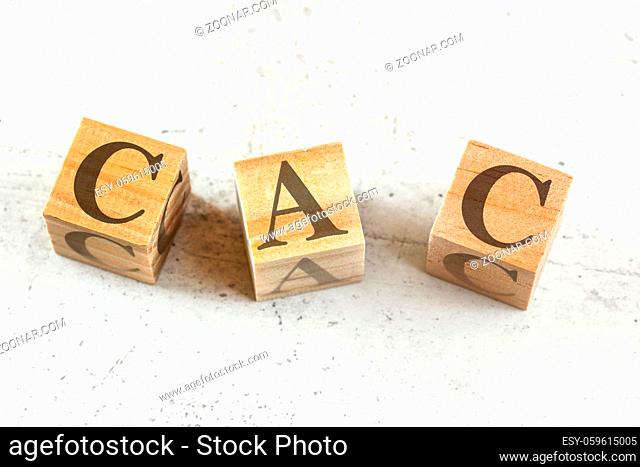 Three wooden cubes with letters CAC stands for Customer Acquisition Cost on white board