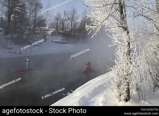 RUSSIA, NOVOSIBIRSK - DECEMBER 8, 2023: Stand up paddle boarders are seen on the Ob River as severe frost hits the city. On 8 December