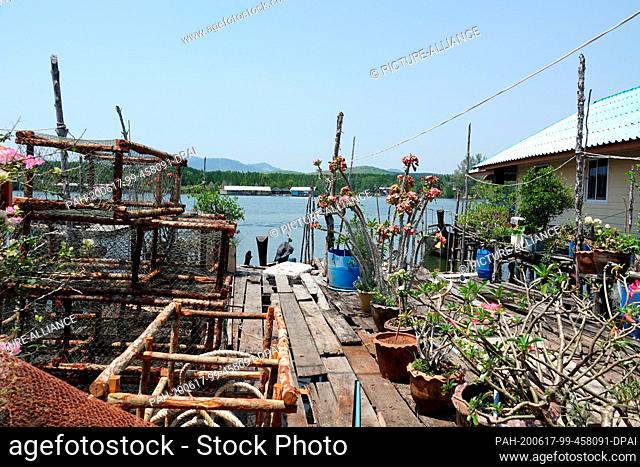 01 March 2020, Thailand, Baan Sam Chiong Nuea: Fishing trips stand on a jetty in the Muslim fishing village Baan Sam Chong Nuea in the Andaman Sea
