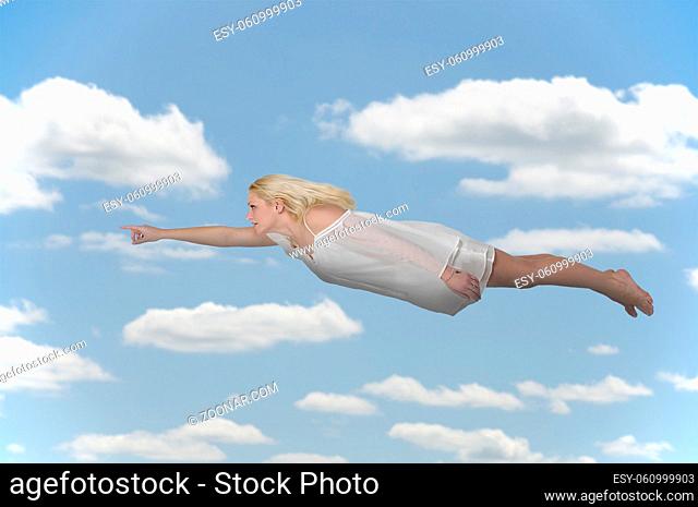 Beautiful young woman flying or falling through the air