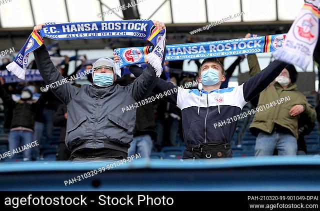 20 March 2021, Mecklenburg-Western Pomerania, Rostock: Football: 3. league, Hansa Rostock - Hallescher FC, 29. matchday, Ostseestadion: Fans are happy about the...