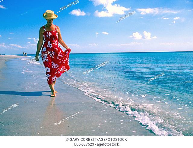 Woman in a nice dress walking, Casperson beach at Venice, Florida (USA)