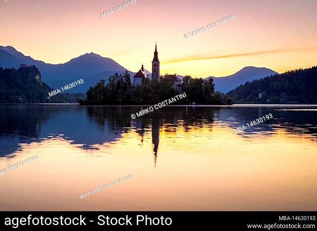 View of lake Bled at in spring with the small island and Assumption of Maria church at dawn. Bled, Upper Carniola, Slovenia