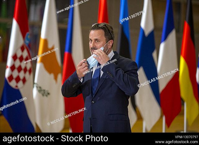 Prime Minister of Luxembourg Xavier Bettel takes off his mouth mask as he arrives for a special meeting of European council called in emergency after the launch...