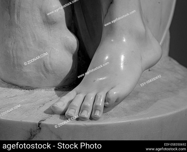 Detail of a marble statue, depicting the foot. Close up of the toes on a foot of an old stone sculpture