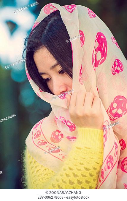 Girl with scarf covering head