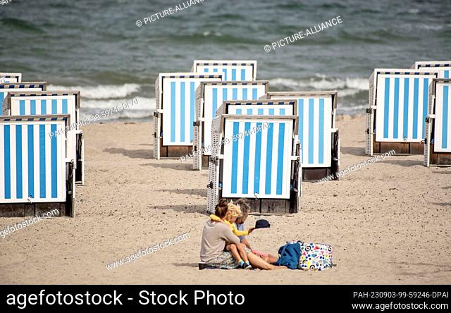 03 September 2023, Mecklenburg-Western Pomerania, Rostock Warnemünde: Shuttered beach chairs stand on the Baltic Sea beach of Warnemünde