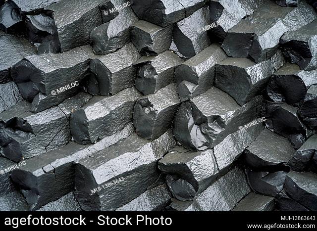 Close up of basalt columns on black sand beach. Iceland
