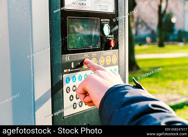 Payment for parking in the City of Gdansk, Poland on February 8, 2020. A person uses monobank credit card for nfc payment in parking terminal