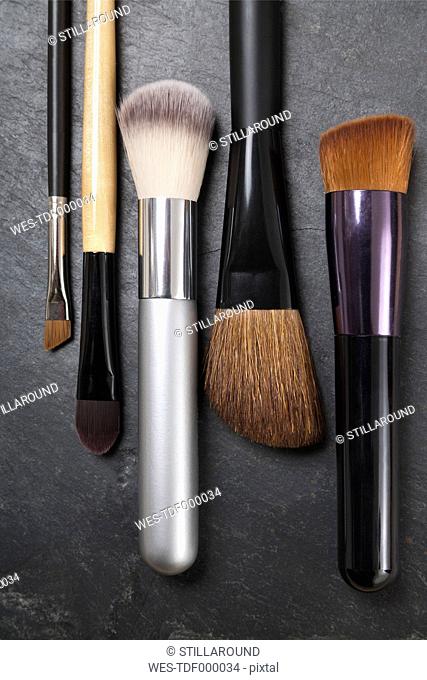 Make up brushes on slate board, close up