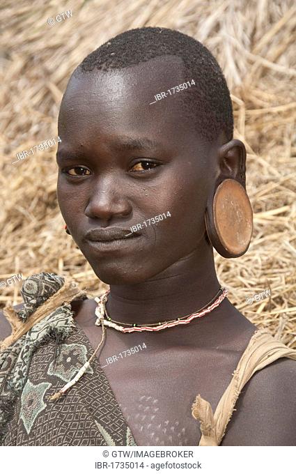Surma woman wearing earplates, Kibish, Omo valley Valley, Ethiopia, Africa