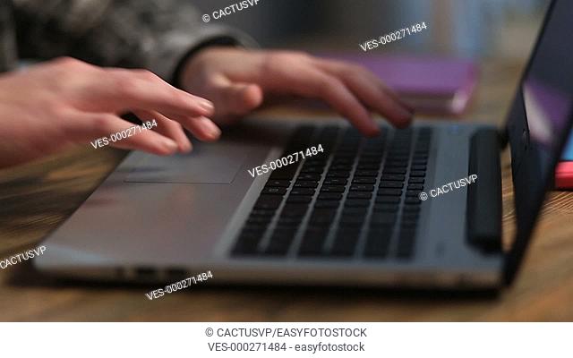 Closeup of man's hands working on laptop