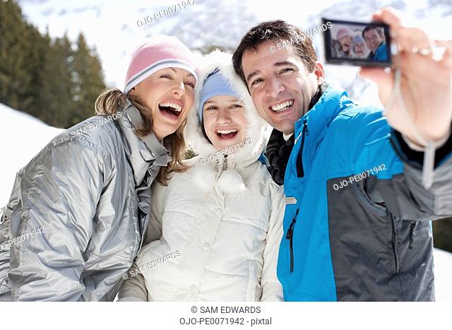 Family taking self-portrait in snow