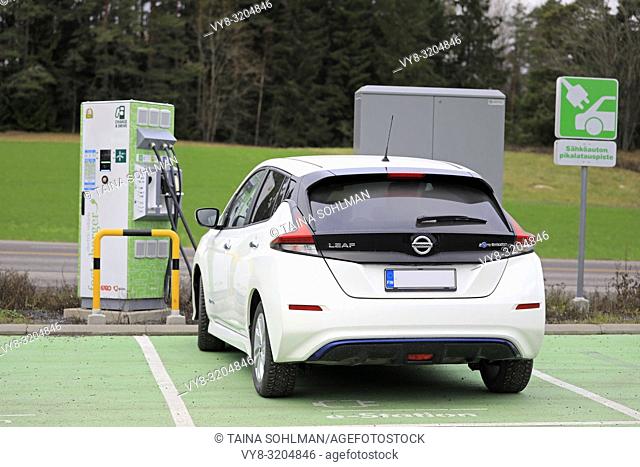 Salo, Finland - November 23, 2018: Nissan Leaf electric car charging battery at Fortum Charge & Drive Fast Charger in South of Finland, rear view
