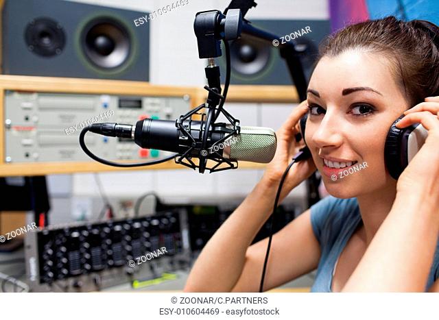 Young radio host putting her headphones on