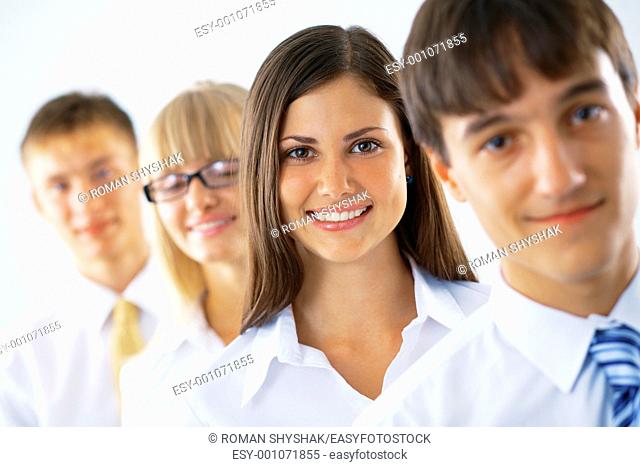 Happy business woman with her colleagues standing in a row