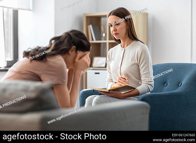psychologist and woman at psychotherapy session