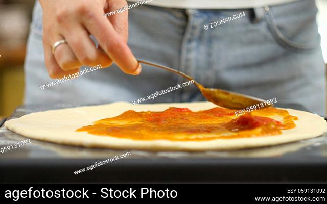 Cooking pizza. The chef prepares the pizza dough. A man or woman is engaged in home business preparing a delicious pizza. 4K