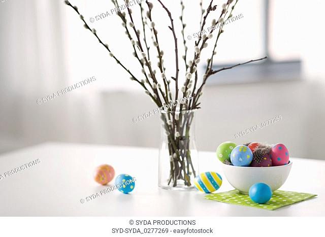 pussy willow branches and colored easter eggs