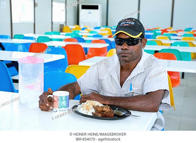 Man in the refinery and harbour area canteen of the Ramu Nickel Mine, chinese mining company, Basamuk, Papua New Guinea, Melanesia