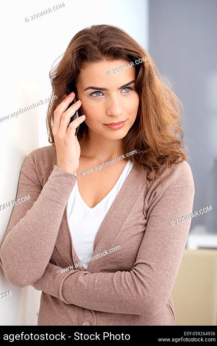 Attractive young woman using mobile at home