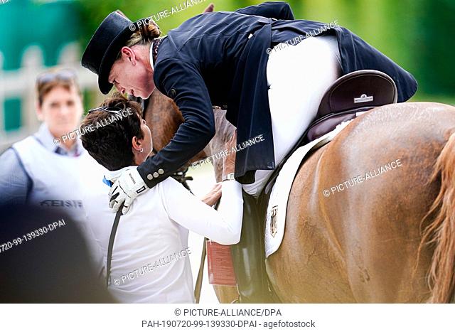 20 July 2019, North Rhine-Westphalia, Aachen: Equestrian sport, CHIO, dressage: The German dressage rider Isabell Werth on the horse Bella Rose embraces Monica...