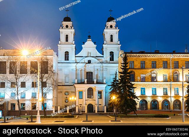 Minsk, Belarus. View Of Cathedral Of Saint Virgin Mary And Part Of Building Of French Embassy In Republic Of Belarus In Evening Night Illuminations