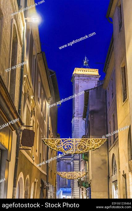 Christmas Holiday Decorations Stores Shops Narrow Street Old Clock Tower Nimes Gard France. Rebuilt in 1700s originally a 1500s belfry