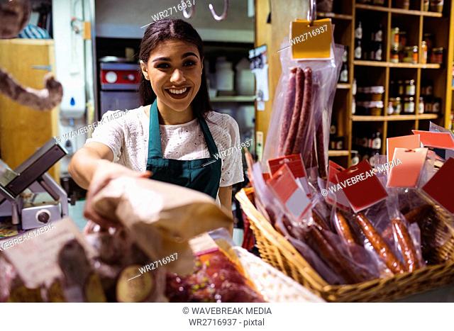 Female staff working at meat counter