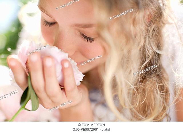 Close up of girl smelling pink flowers
