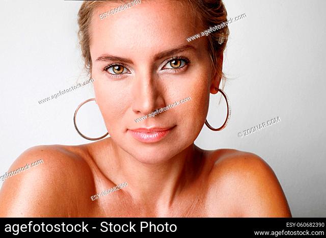 Caucasian young woman with blonde hair, looking at the camera. Beauty skin concept. High quality photo