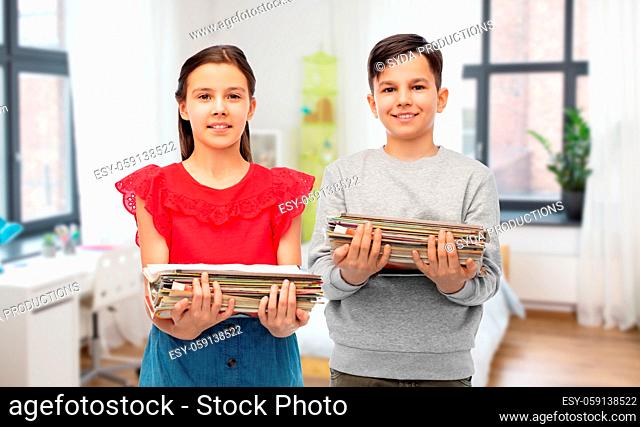 happy children with magazines sorting paper waste