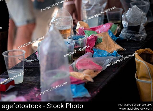 30 July 2022, North Rhine-Westphalia, Neuss: Packets of colored powder lie on a table. The ""Farbgefühle"" festival, also called the ""Holi Festival of Colours