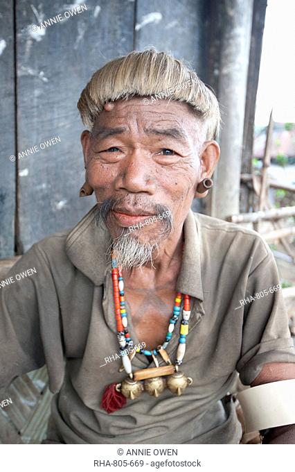 Naga Konyak tribal head hunter with traditional headhunter necklace with brass heads, bamboo earrings, elephant tusk armbands, Ngangting, Nagaland, India, Asia
