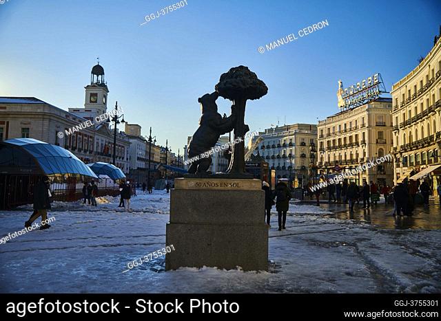View of Puerta del Sol Square and Oso and Madrono Statue with people taking pictures and enjoying the snowy landscape on January 11, 2021 in Madrid, Spain