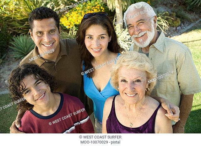 Boy 13-15 with parents and grandparents outside elevated view portrait