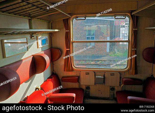 The interior of an old train compartment, railway vehicle, train compartment of the DB, view aug tracks, compartment window of a train, empty train compartment
