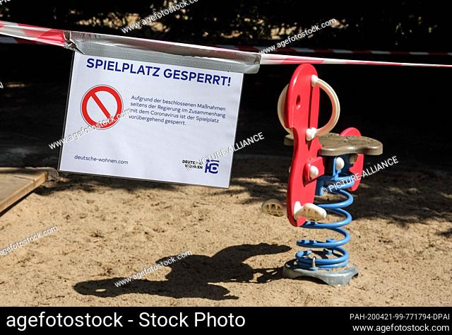 17 April 2020, Berlin: Barrier tapes and a sign ""Spielplatz gesperrt"" (playground closed) are attached to a playground in Charlottenburg