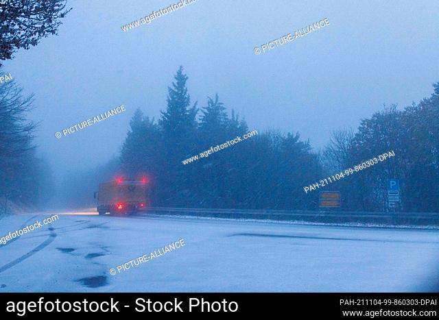 04 November 2021, Baden-Wuerttemberg, Freiburg im Breisgau: A truck drives through the freshly fallen snow near the summit of the Schauinsland mountain