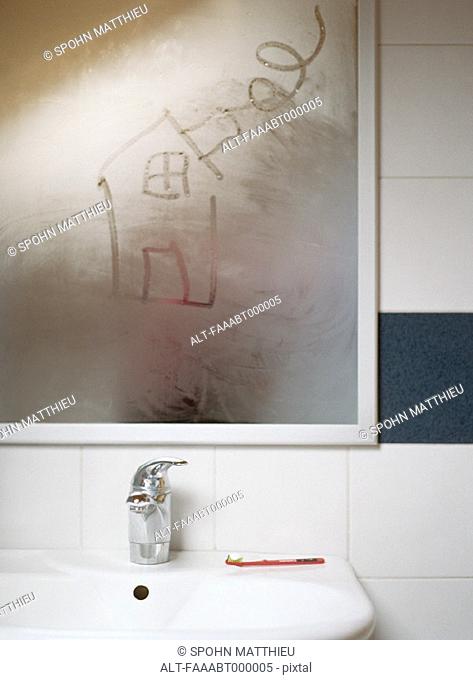 House drawn in condensation on bathroom mirror