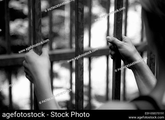 Close up of hands in a prison cell, jail